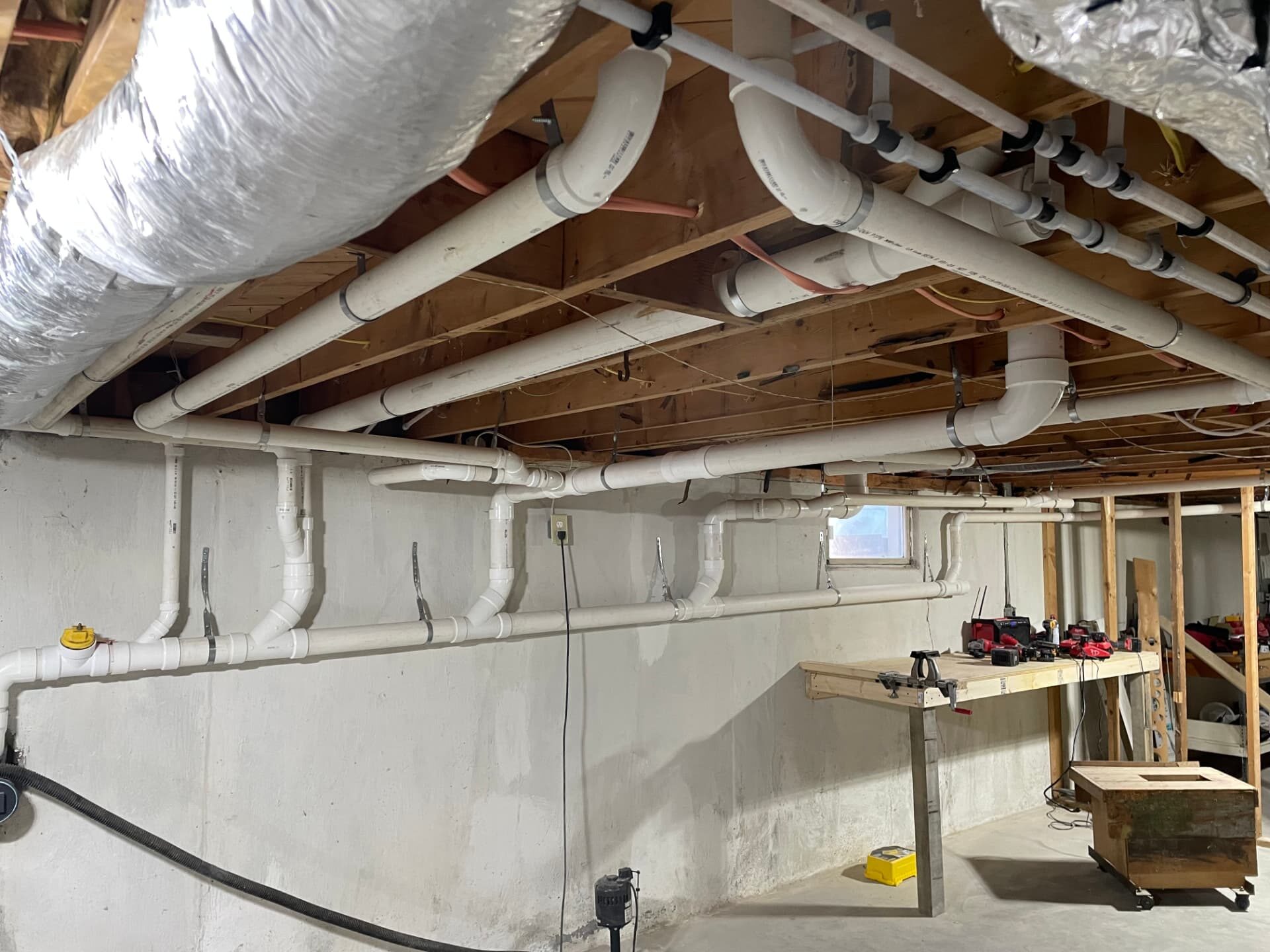 Professional plumbing rough-in installation for new construction by Top Shelf in Lowell