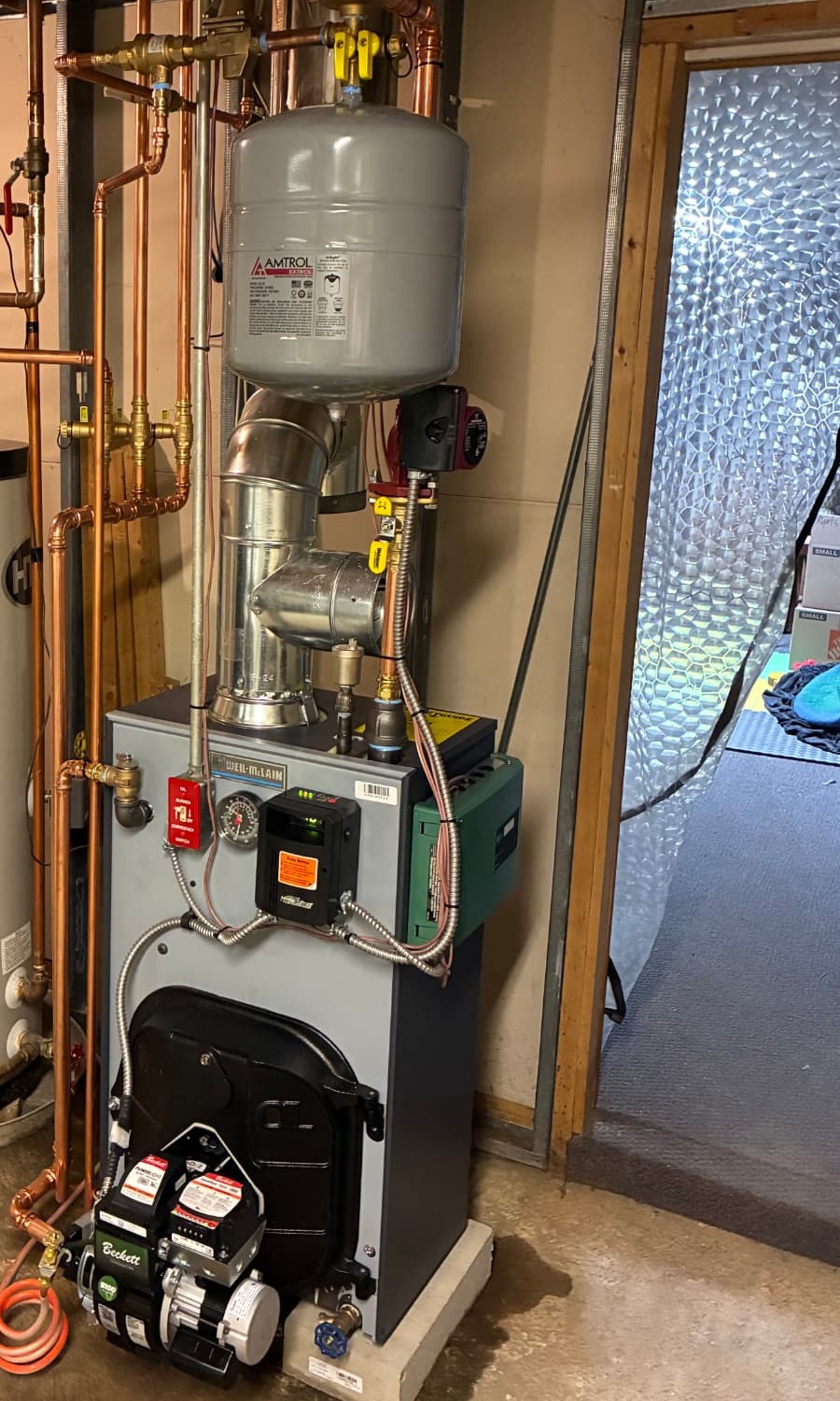 Boiler installed and serviced by Top Shelf Plumbing & Heating with clean copper piping