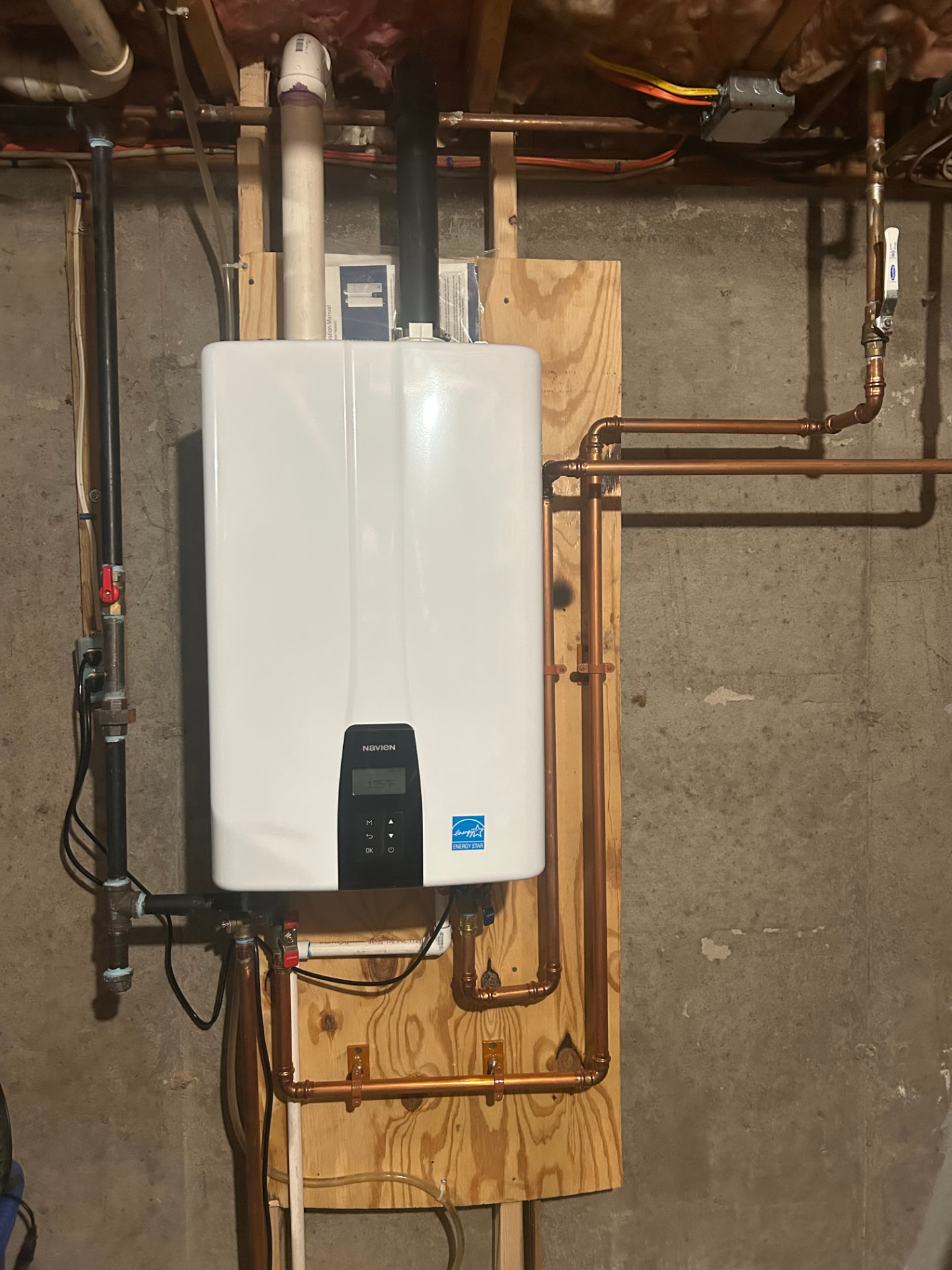 Tankless water heater install in Tyngsborough, MA with copper piping by Top Shelf Plumbing & Heating