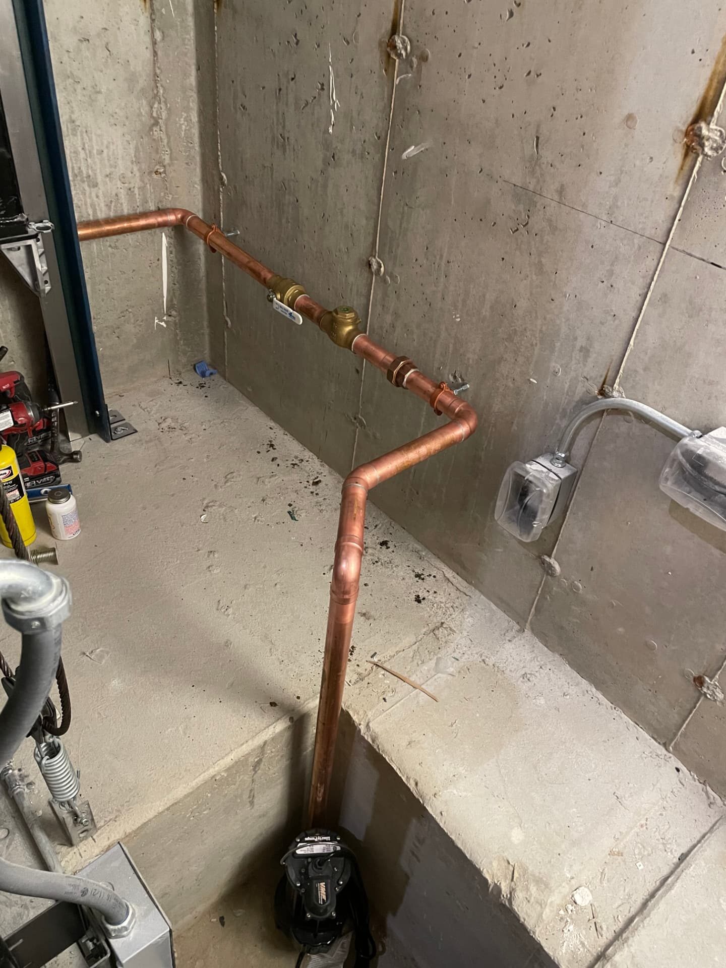 Elevator sump pump installation with copper discharge piping in North Andover, MA by Top Shelf Plumbing & Heating